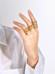 Detailed view of layered 18k gold plated stainless steel chain rings on model hand
