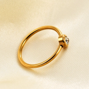 Macro shot of 2mm 18K gold plated stainless steel ring with a single sparkling zircon