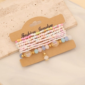Detail of bohemian multilayer beaded bracelet with colorful seed beads on marble surface
