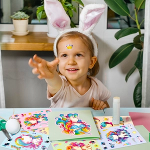 Toddler playing with cartoon unicorn stickers showing creative DIY fun on forehead