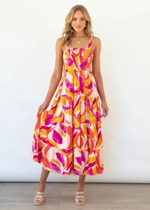 Detailed view of pink floral tiered maxi dress with ruched waist and adjustable straps