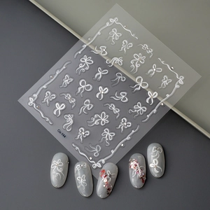 5D embossed nail stickers featuring white bows and pearls for 3D DIY manicures