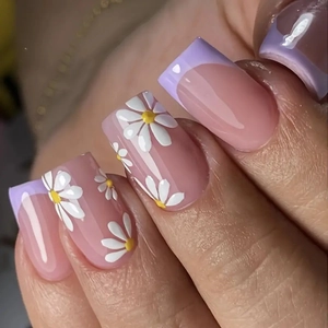 Short French square nails with nude pink base, lilac tips and white daisy floral patterns