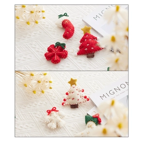 Close-up of handmade red and white wool felt Christmas tree, sock and snowflake charms