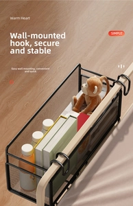Detail of black metal mesh bedside basket showing strong weight capacity with books and drinks