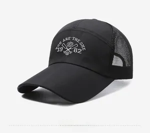 Detail of black baseball cap showing white embroidery and breathable mesh back