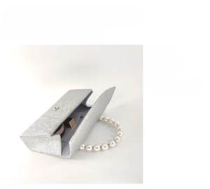Detail view of silver glitter evening clutch with pearl handle and interior compartments