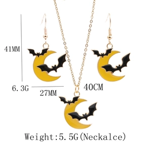Detail view of yellow moon and black bat Halloween jewelry set with size dimensions