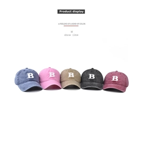 Detail showing five colors of washed cotton baseball caps with embroidered B letter
