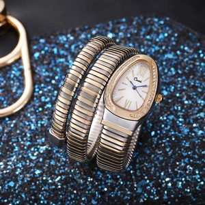Close-up of snake wrap watch with silver gold tones and crystal-encrusted drop dial