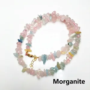 Macro detail of natural irregular morganite chips necklace with gold lobster clasp closure