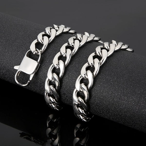 Close-up of a silver Cuban link chain with a large lobster clasp on a black display stand