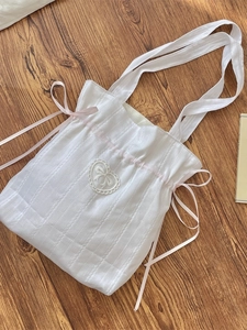 White canvas tote bag with pink satin ribbons and heart lace embroidery in coquette style