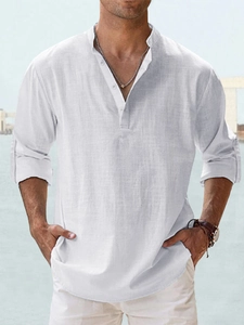 Detail of white cotton linen shirt showing breathable texture and buttoned henley neck collar
