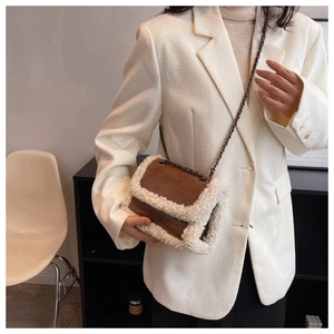 Detail of retro chain shoulder bag with brown leather and white faux fur trim