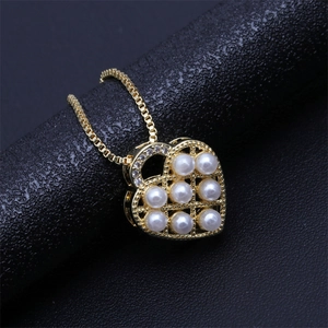 Golden heart necklace with micro-paved zircons and white pearls on mesh base