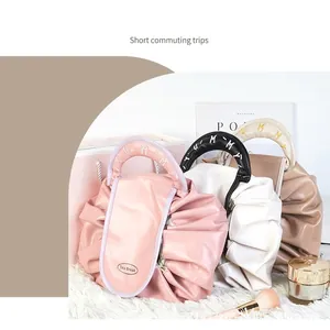 Waterproof drawstring cosmetic bag with pleated cloud design and YUMMY handle detail