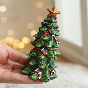 Miniature green resin Christmas tree desk ornament with colorful festive decorations