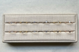 Detailed display of S925 silver rings with various gemstone cuts in a jewelry box