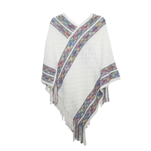 Detailed knit texture of white poncho with rainbow geometric embroidery and fringe