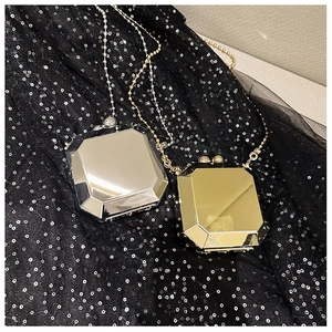 Detail of octagonal gemstone cut mirror metal evening bags in gold and silver colors