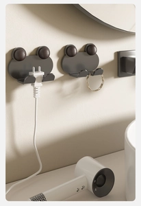 Punch-free cartoon frog plug holder on wall for kitchen cable management and storage