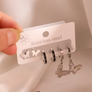 Detailed set of butterfly stud and hoop earrings in polished stainless steel finish