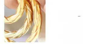 Macro detail of French style 18k gold plated twisted rope design earring texture
