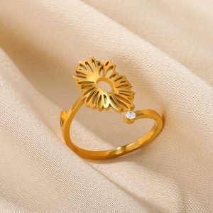 Detailed macro of a hollow sunflower ring with sparkling zircon on gold silk