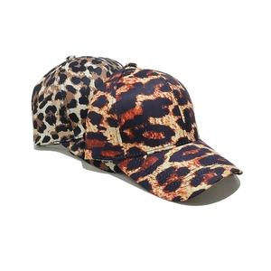 Close-up detail of leopard print baseball caps showing texture and stitching details