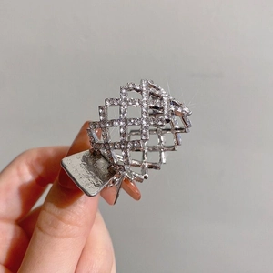 Detailed macro view of silver mesh hair claw clip with sparkling rhinestones decoration