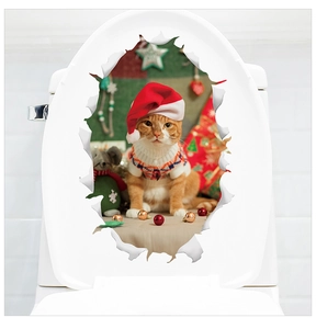 Detail of 3D Christmas orange cat sticker with Santa hat appearing on white toilet lid