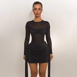 Detail of sheer black mesh bodysuit with bra cups and side ribbons on a mini skirt