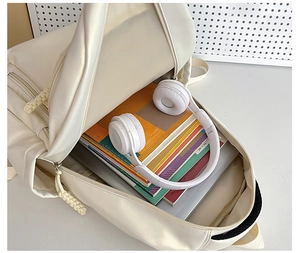 Interior view of white minimalist backpack showing large storage capacity for laptops