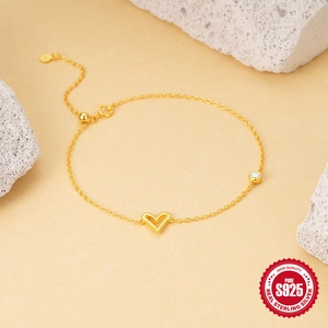 Classic gold S925 sterling silver heart bracelet with round zircon on stone background