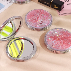 Portable pink quicksand folding makeup mirror with heart sequins and dual-sided lenses