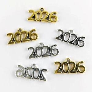 Macro view of gold and silver 2026 number pendants for DIY jewelry and necklaces