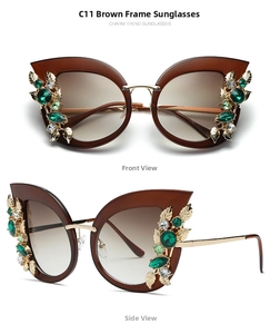 Detail view of cat eye sunglasses with rhinestones, green gems and gold leaf accents