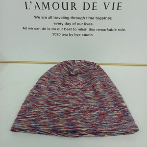 Detailed texture of multi-color knitted beanie with red and blue blended soft yarn fabric