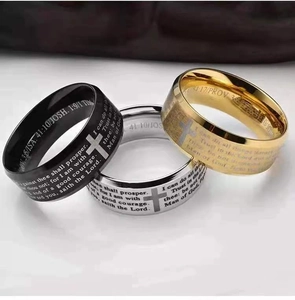 Detail of brushed stainless steel rings with Bible verses and cross engravings