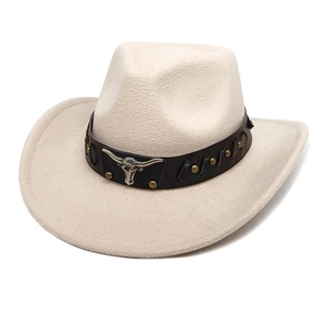 Detail of beige felt cowboy hat featuring leather band and silver bull head metal ornament