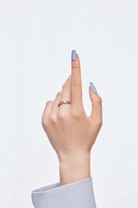 Detailed view of S925 sterling silver ring with pink and purple heart zircons on finger