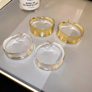 Minimalist wide geometric hoop earrings in brushed gold and silver metal finishes