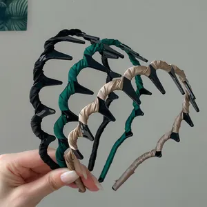 Set of three non-slip wavy fabric headbands in black, dark green, and champagne colors
