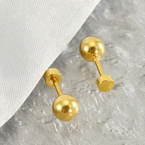 Minimalist polished gold stainless steel ball stud earrings for women on soft textured fabric