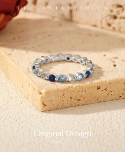 Detail of silver S925 ring featuring a gradient of blue and white crystals on stone