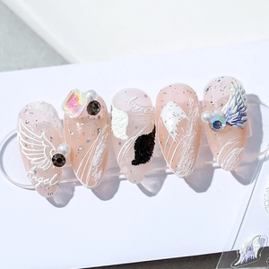 3D 5D Angel Wings nail stickers with silver glitter and pearl details on light pink base
