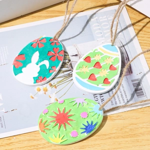 Detailed view of hand-painted Easter egg pendants with bunny designs and jute twine