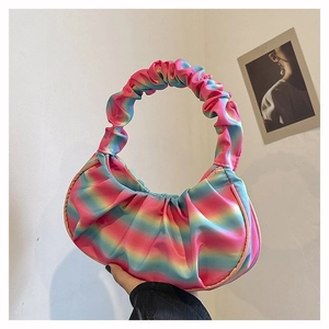 Close-up of ruched rainbow gradient shoulder bag with colorful satin fabric texture