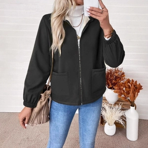 Detail of a women's black zip-up jacket with stand collar and front pockets style